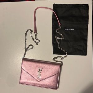 Light iridescent pink YSL wallet on a chain.